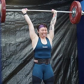 Happy woman lifting weights